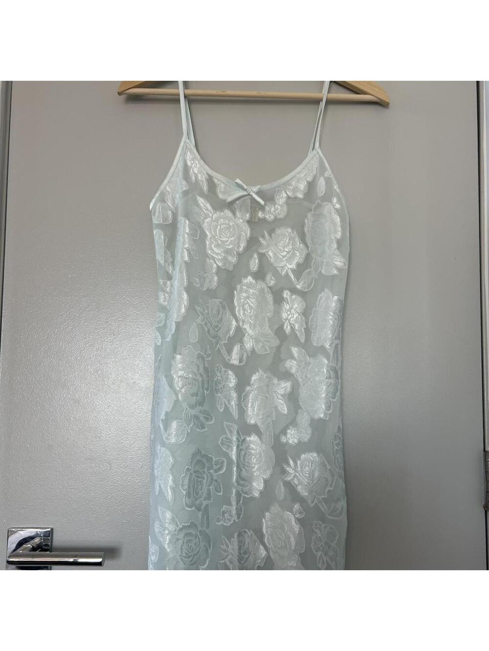 White lace slip dress with floral embroidery and bow detail